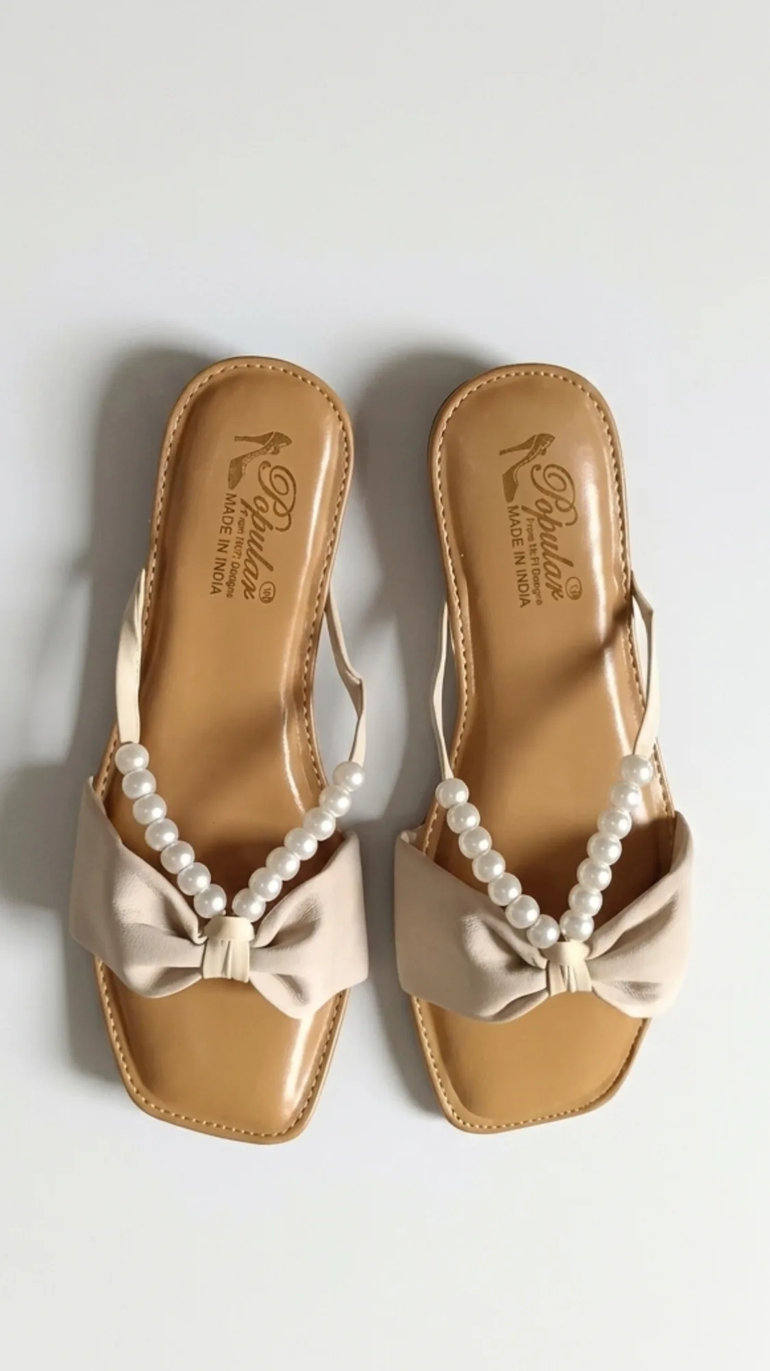 Classy beige strap with pearl embellishment and a stylish bow front.